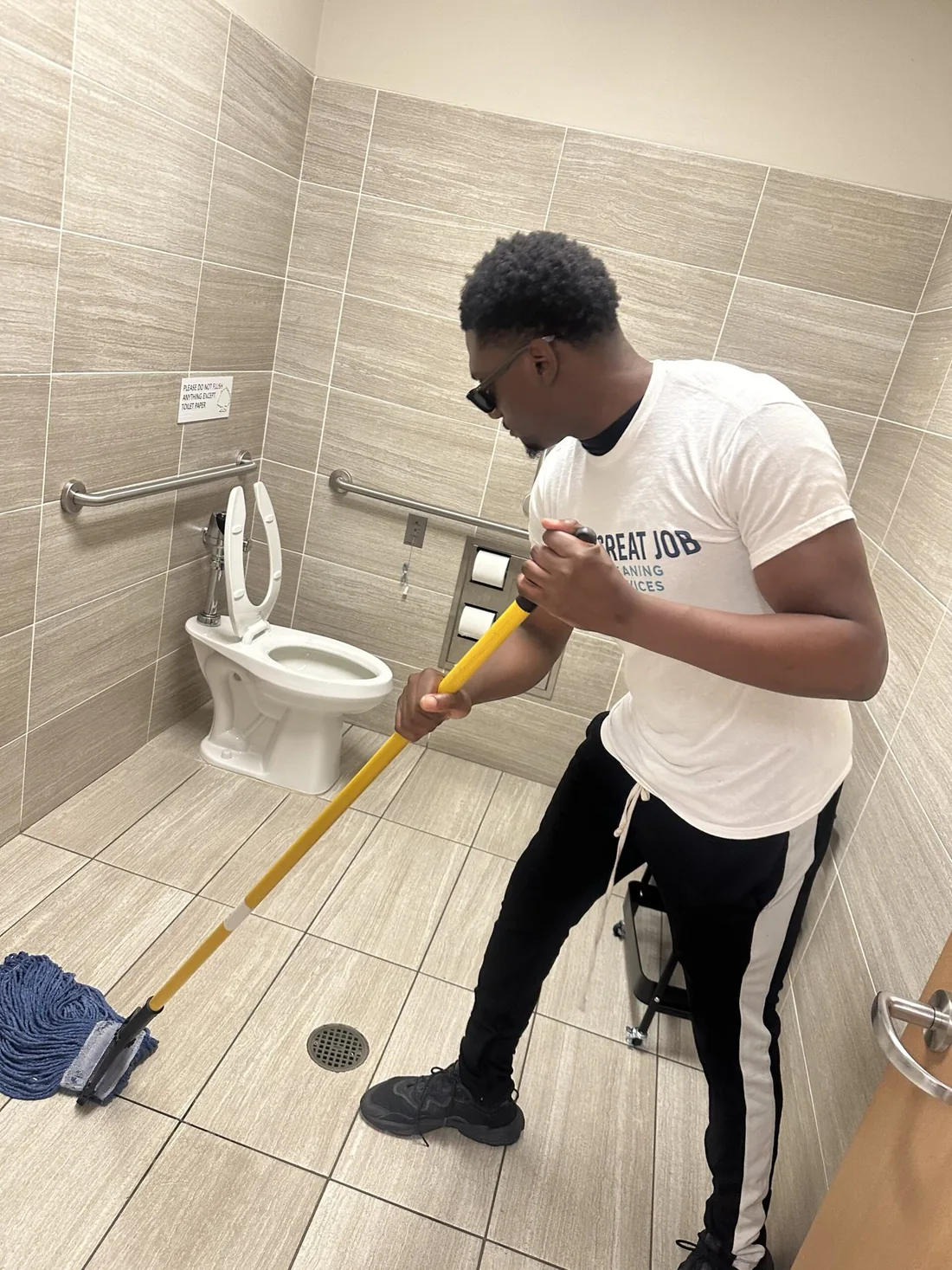 Great Job team member servicing a commercial restroom
