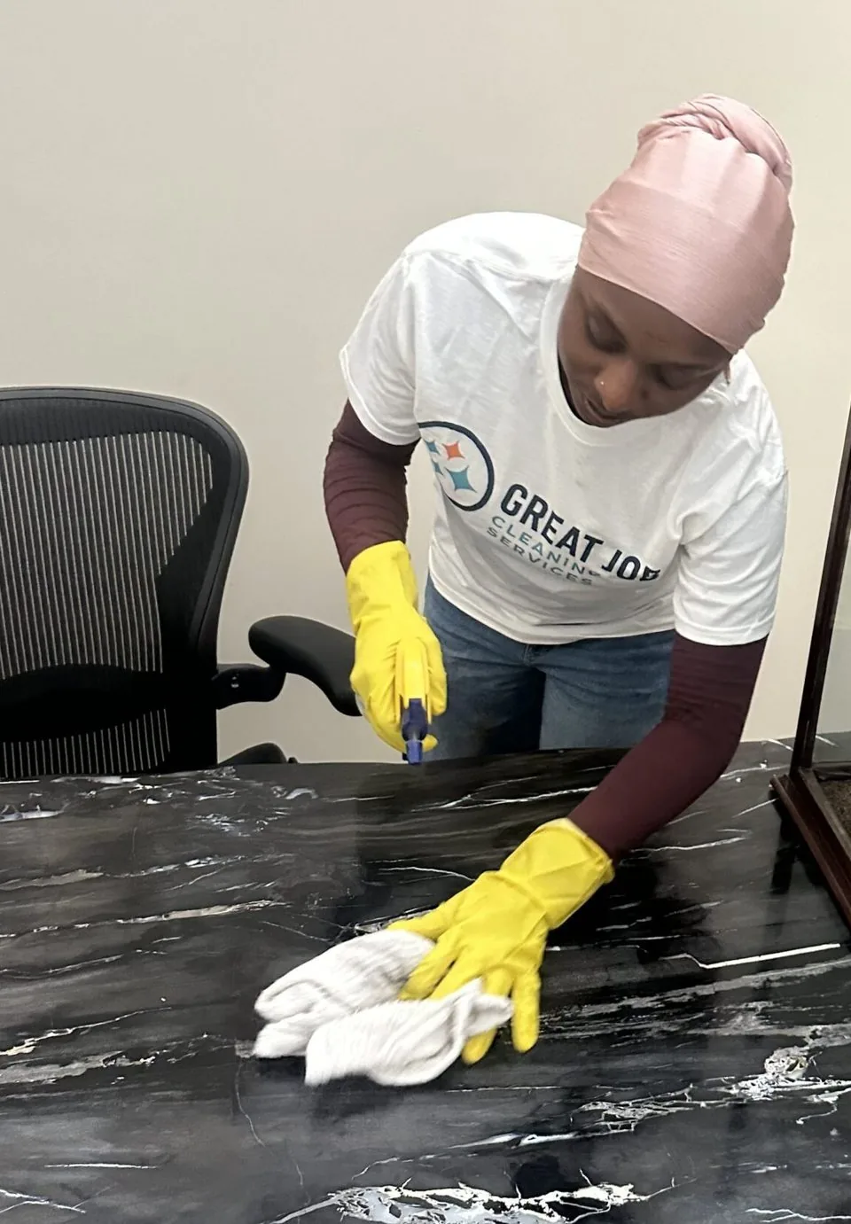 Great Job team member cleaning a reception counter